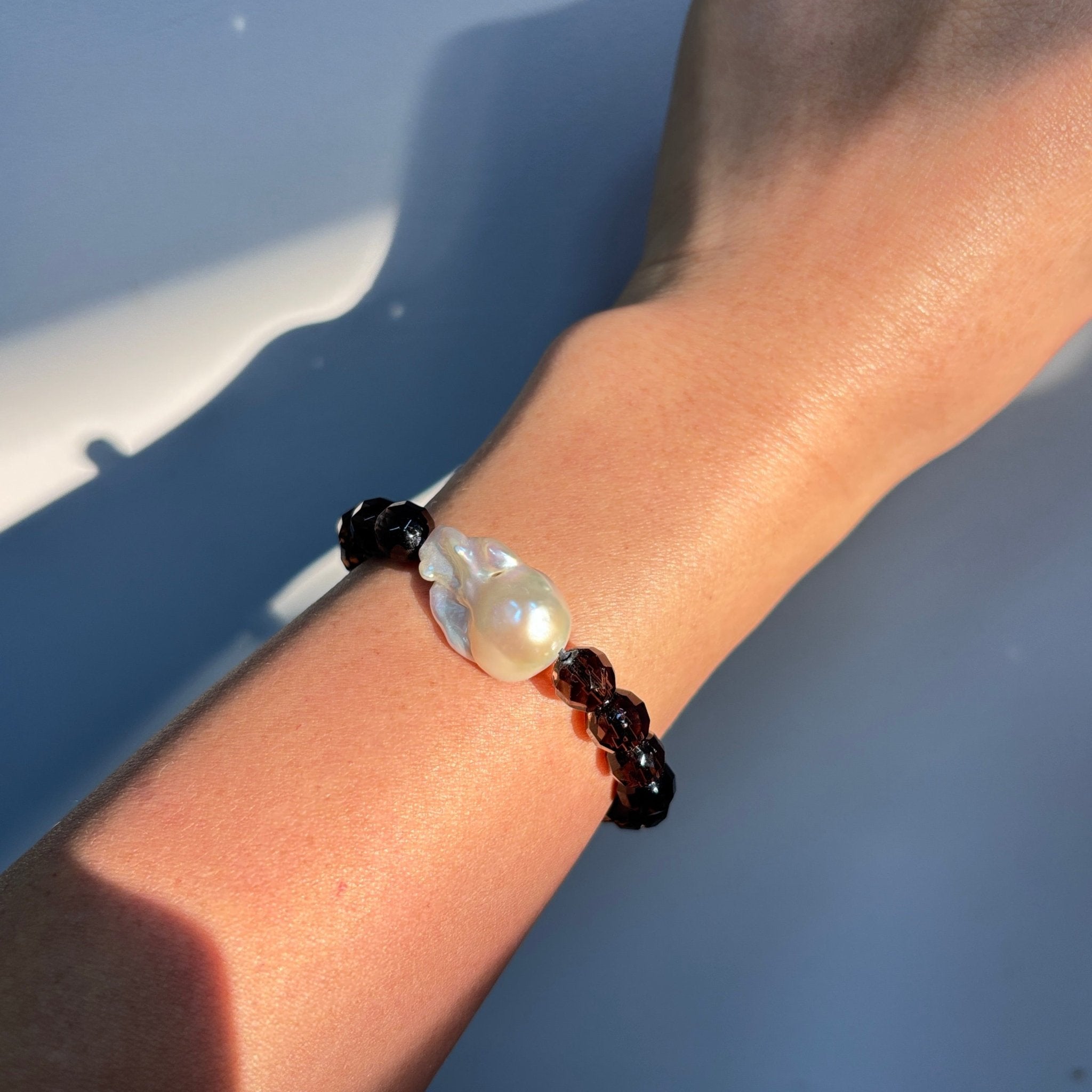 Model wearing Midnight Veil Smoky Quartz & Baroque Pearl Bracelet