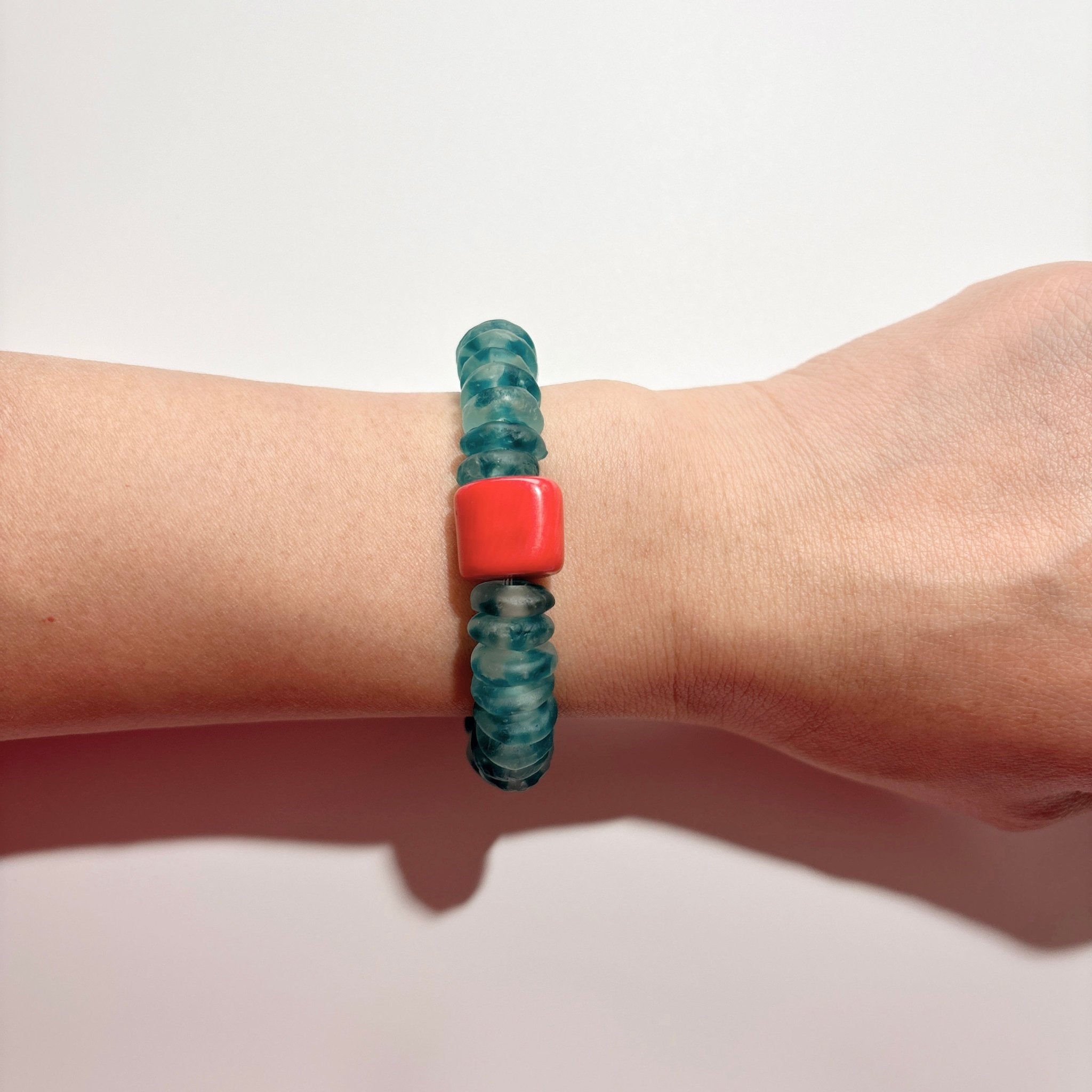 Model wearing Tidebreak Ocean Blue Glass & Red Coral Beaded Bracelet